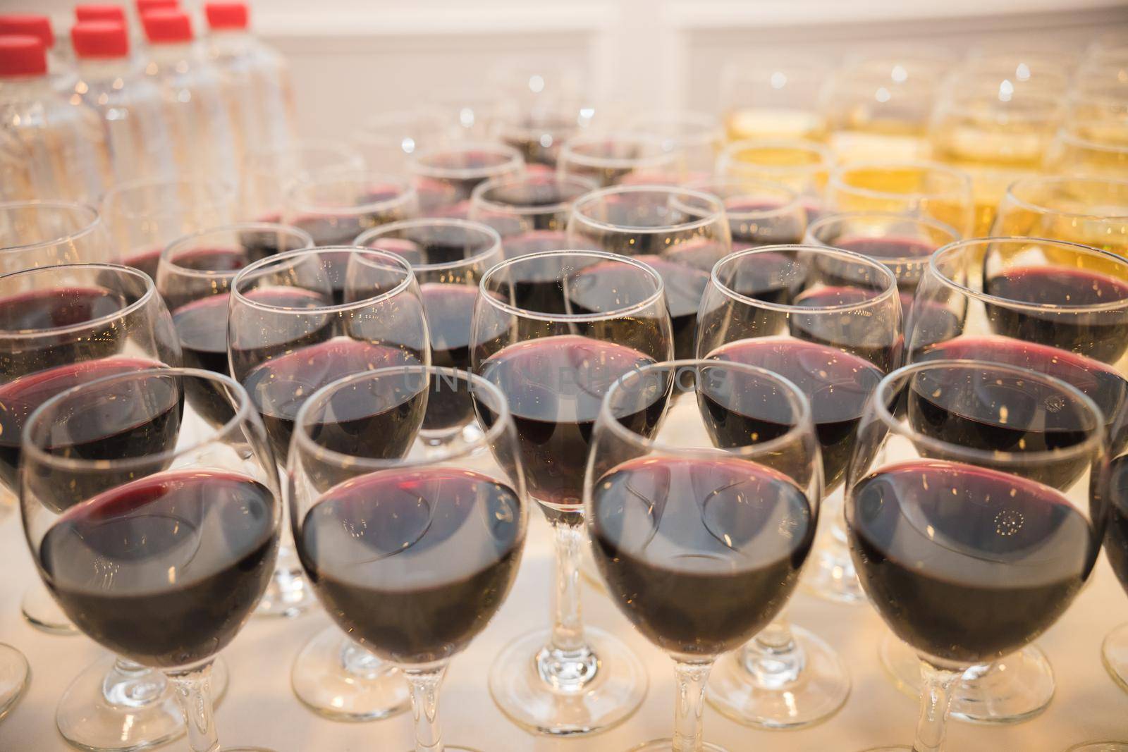 Glasses with alcohol, wine and different drinks on the table