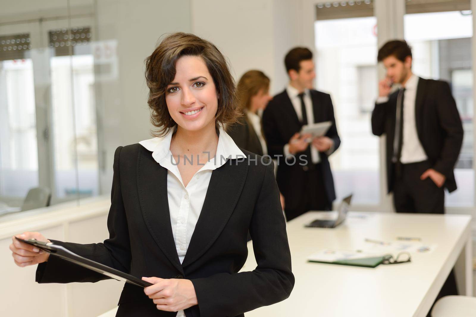 Image of business leader looking at camera in working environment