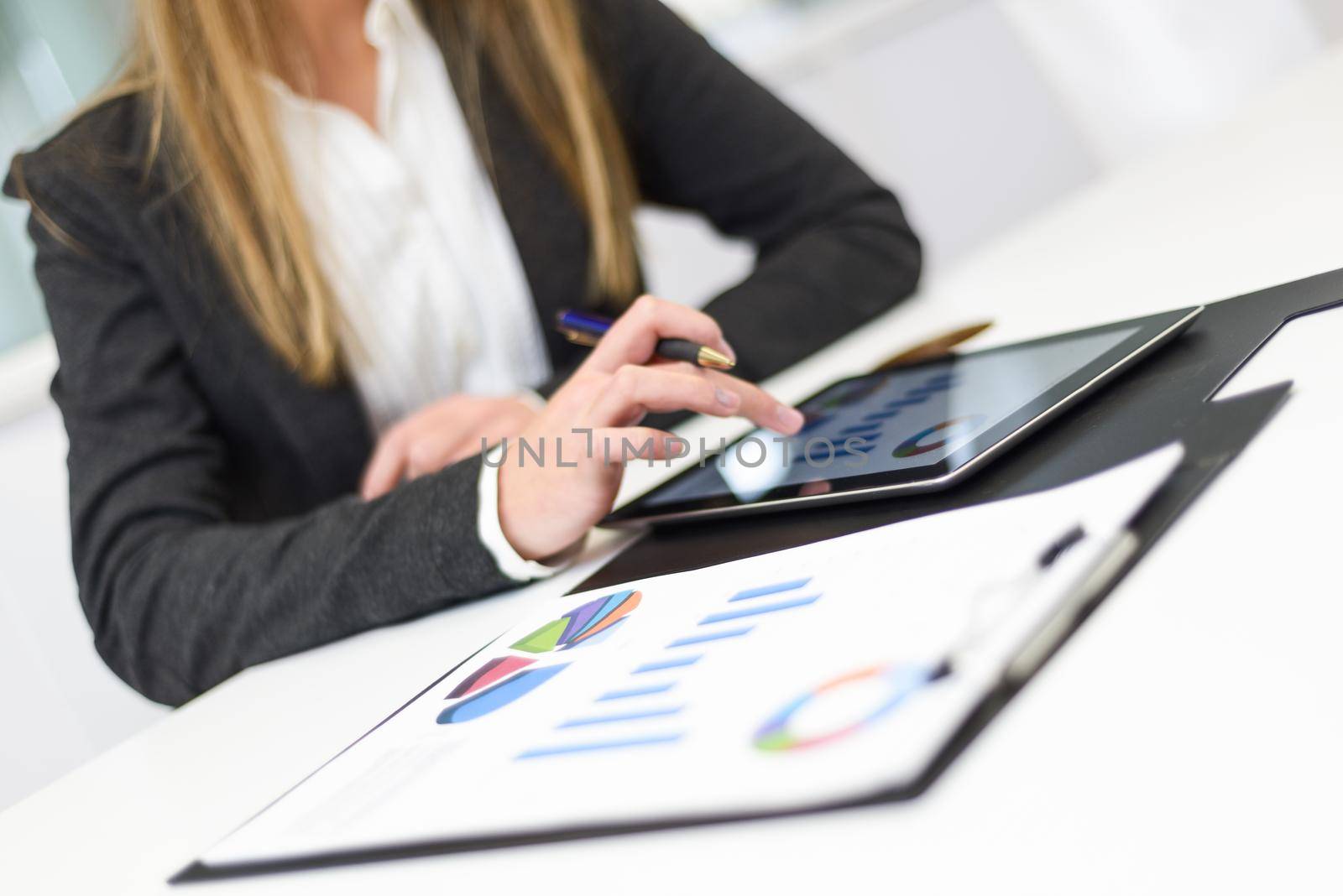 Businesswoman with tablet computer in the office by javiindy