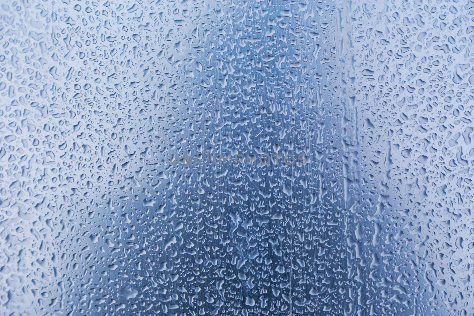 Water droplets or Rain Drops On Glass Textured Blue Background. by lunarts
