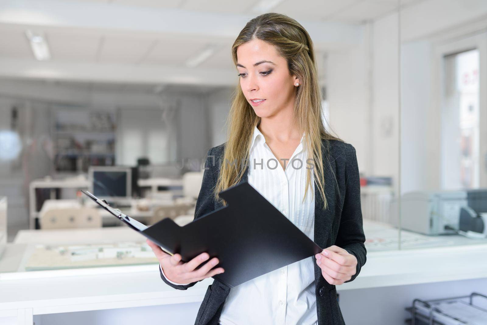 Businesswoman in modern glass interior by javiindy