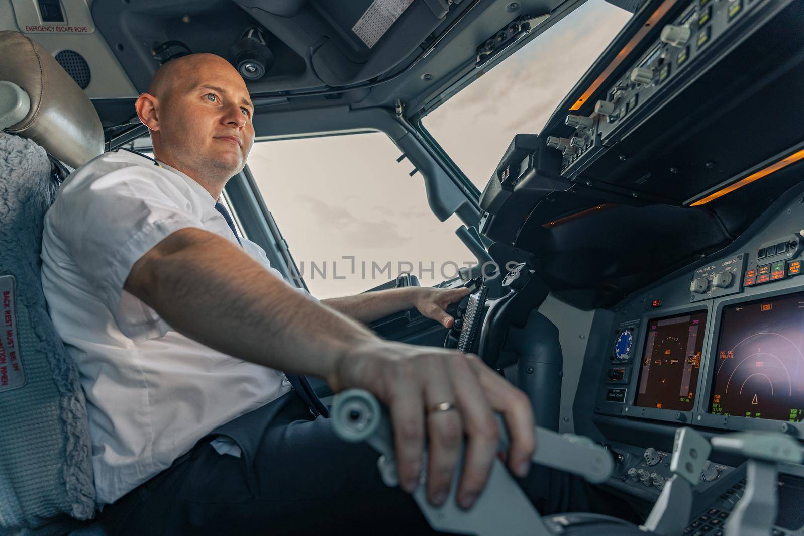 Low angle of a professional pilot sitting at aircraft steering wheel. Profession concept
