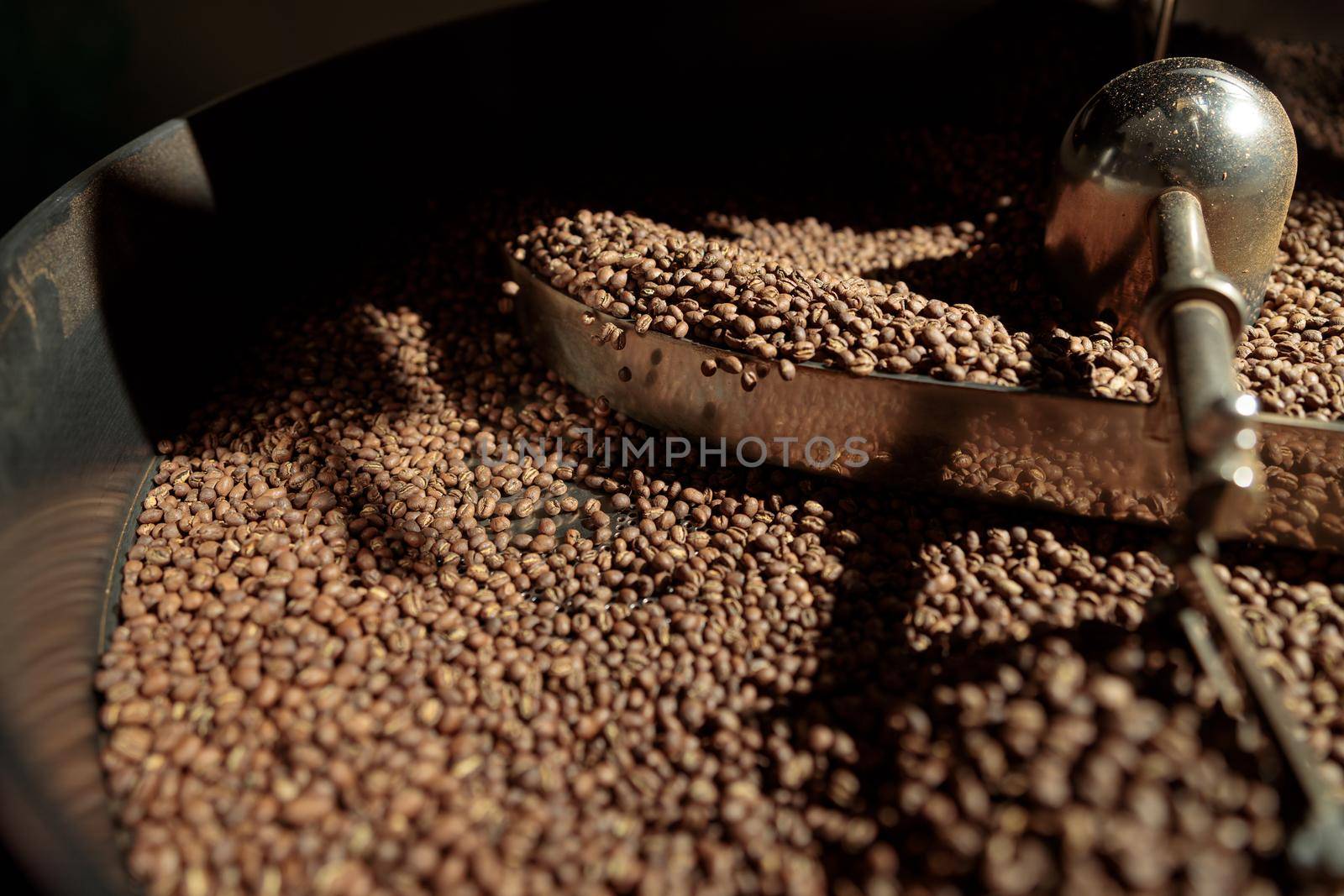 Coffee processing. Roastery, roasting machine and fresh beans by Yaroslav_astakhov