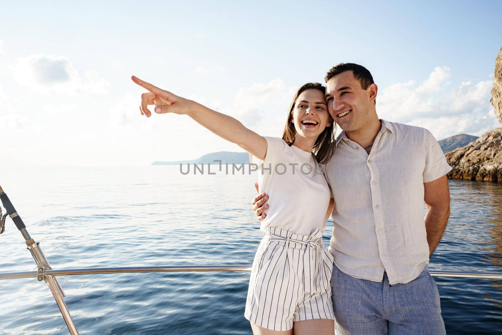 Happy couple in love on a yacht in summer on romantic vacation