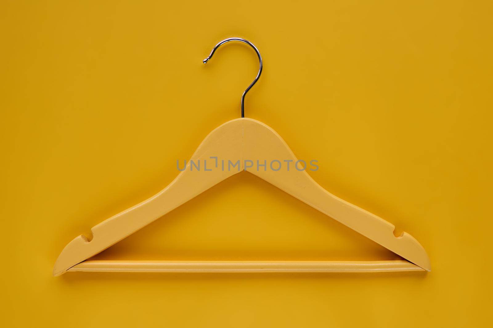 Wooden Coat hanger with black paper label isolated on yellow paper background. Clothing tag, label blank mockup template, to place your design. Black friday final sale banner.