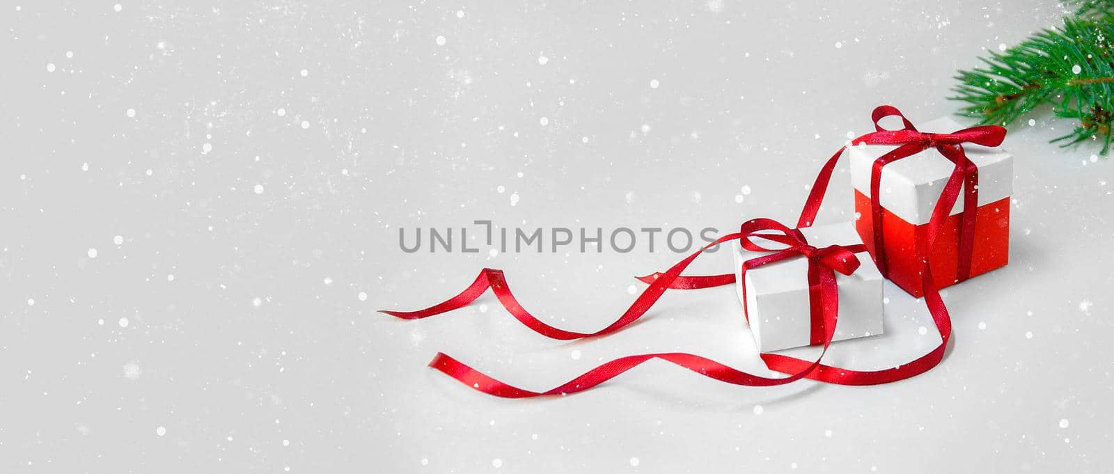 Christmas Gift's in White Box with Red Ribbon on Light Background. New Year Holiday Composition Banner. Copy Space For Your Text