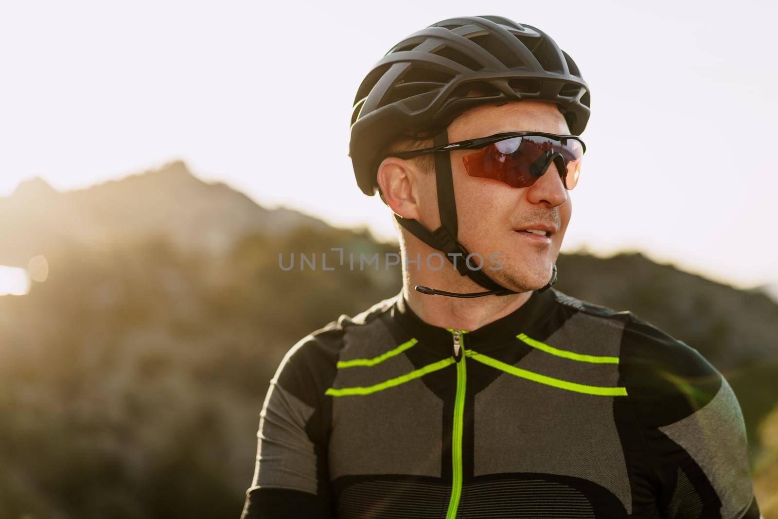 Portrait of male caucasian cyclist with helmet and glasses close up