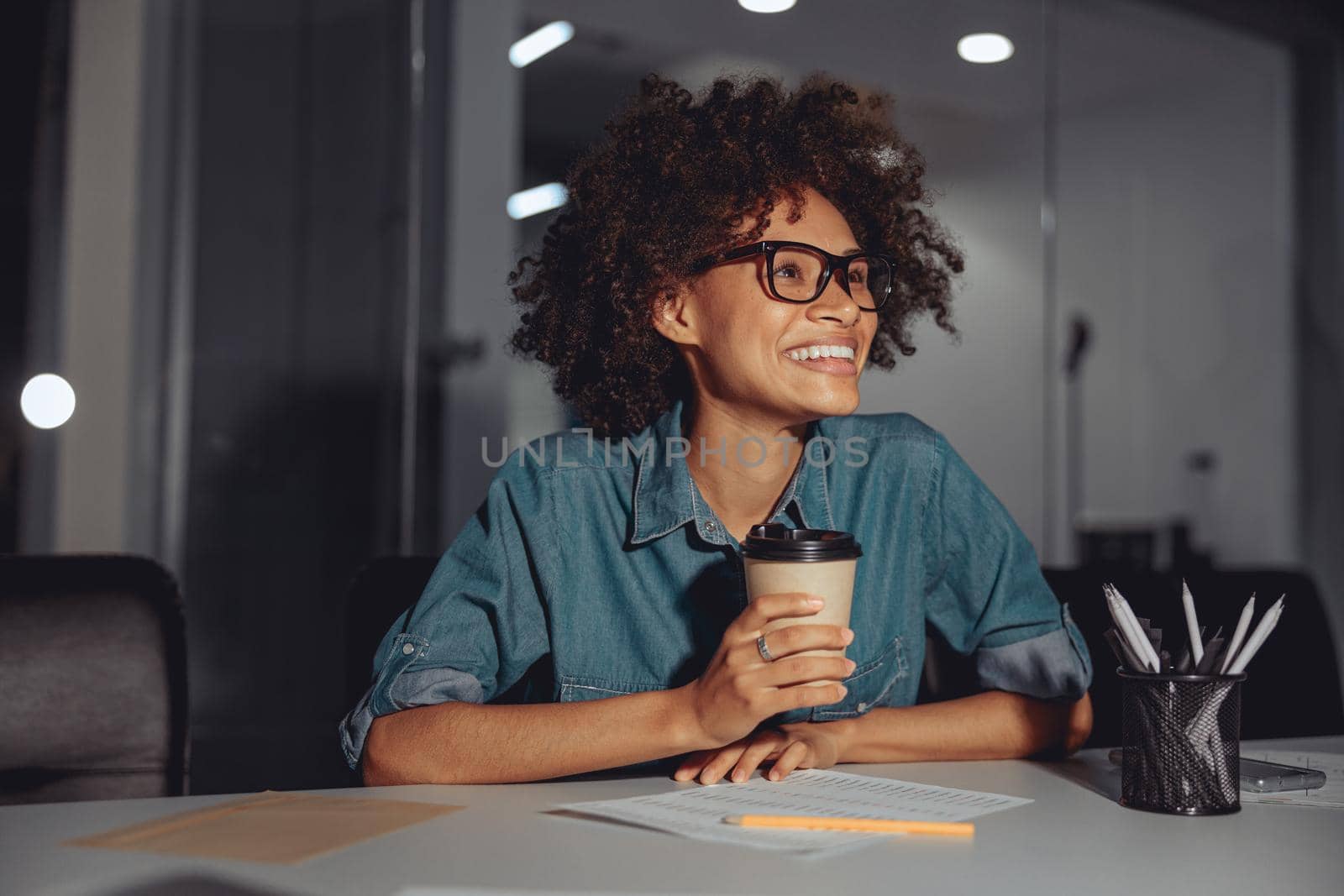 Happy Afro American woman in glasses working at workplace by Yaroslav_astakhov