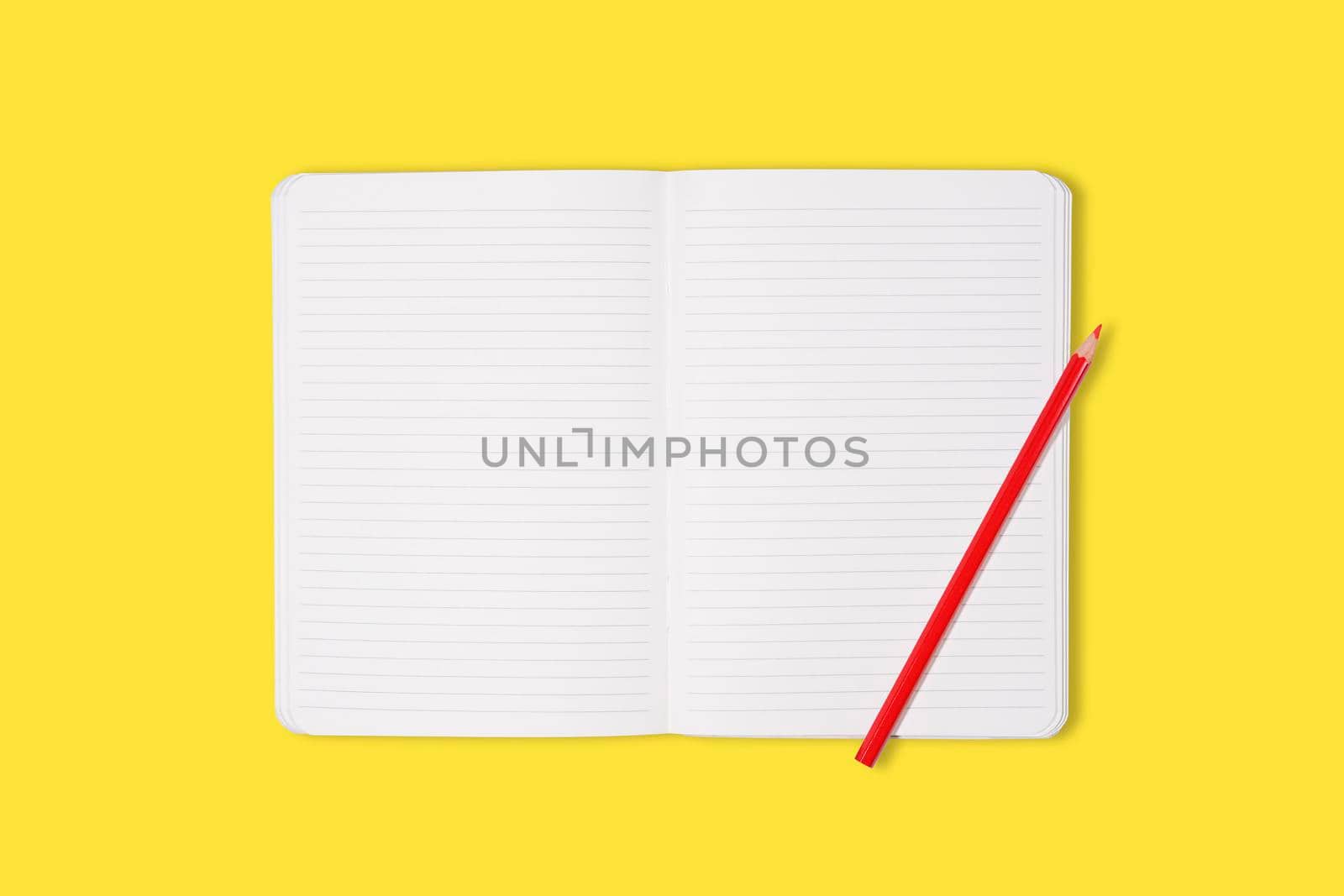 School or office notebook with red pencil isolaed on yellow background. Top view. Mock up