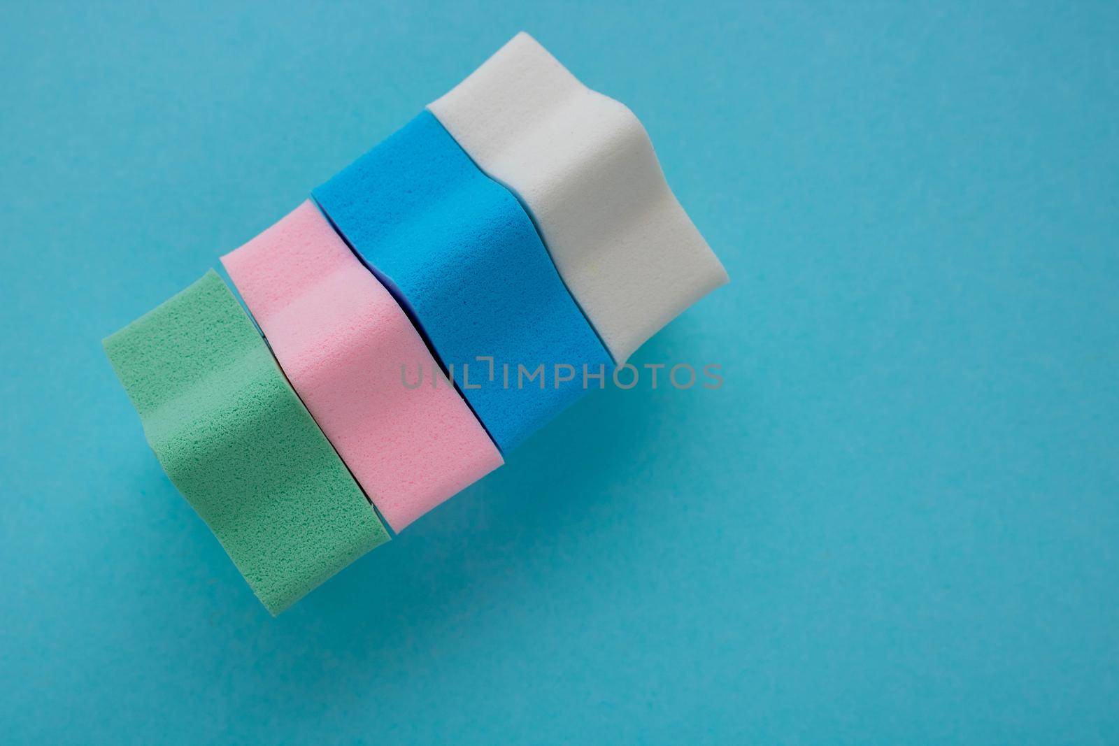 Set of sponge for cleaning face makeup on a blue background.