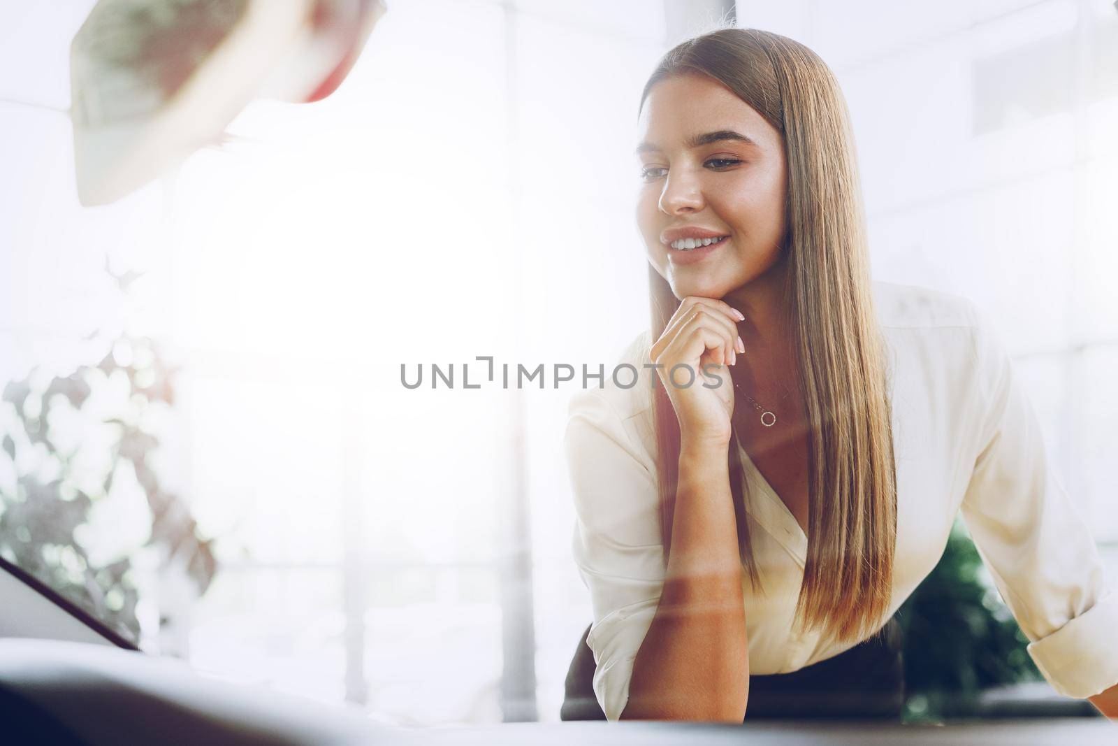 Young woman checking out a new car she is going to buy in car salon