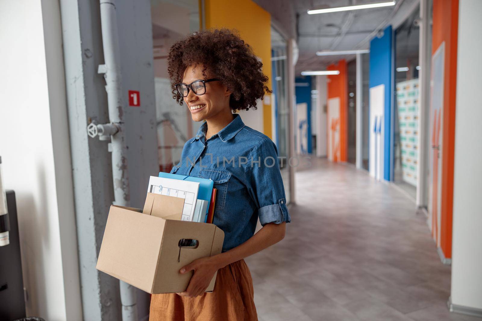 Happy female employer walking around the office with documents by Yaroslav_astakhov