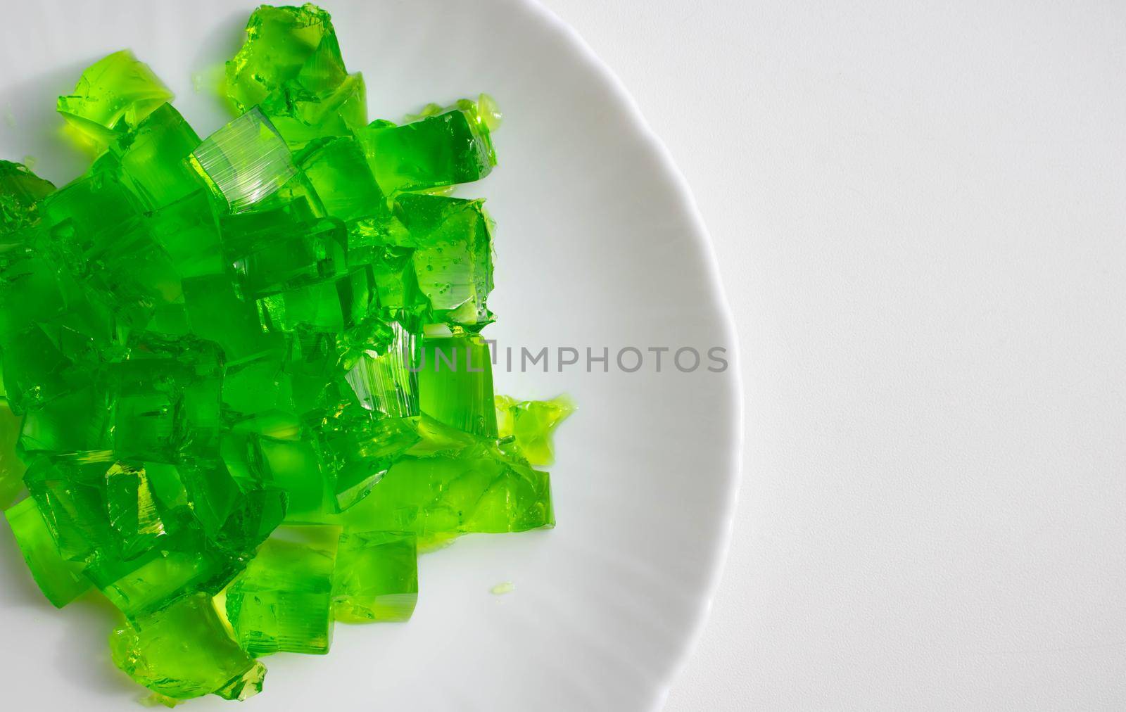 Delicious green jelly cube on white background by lapushka62