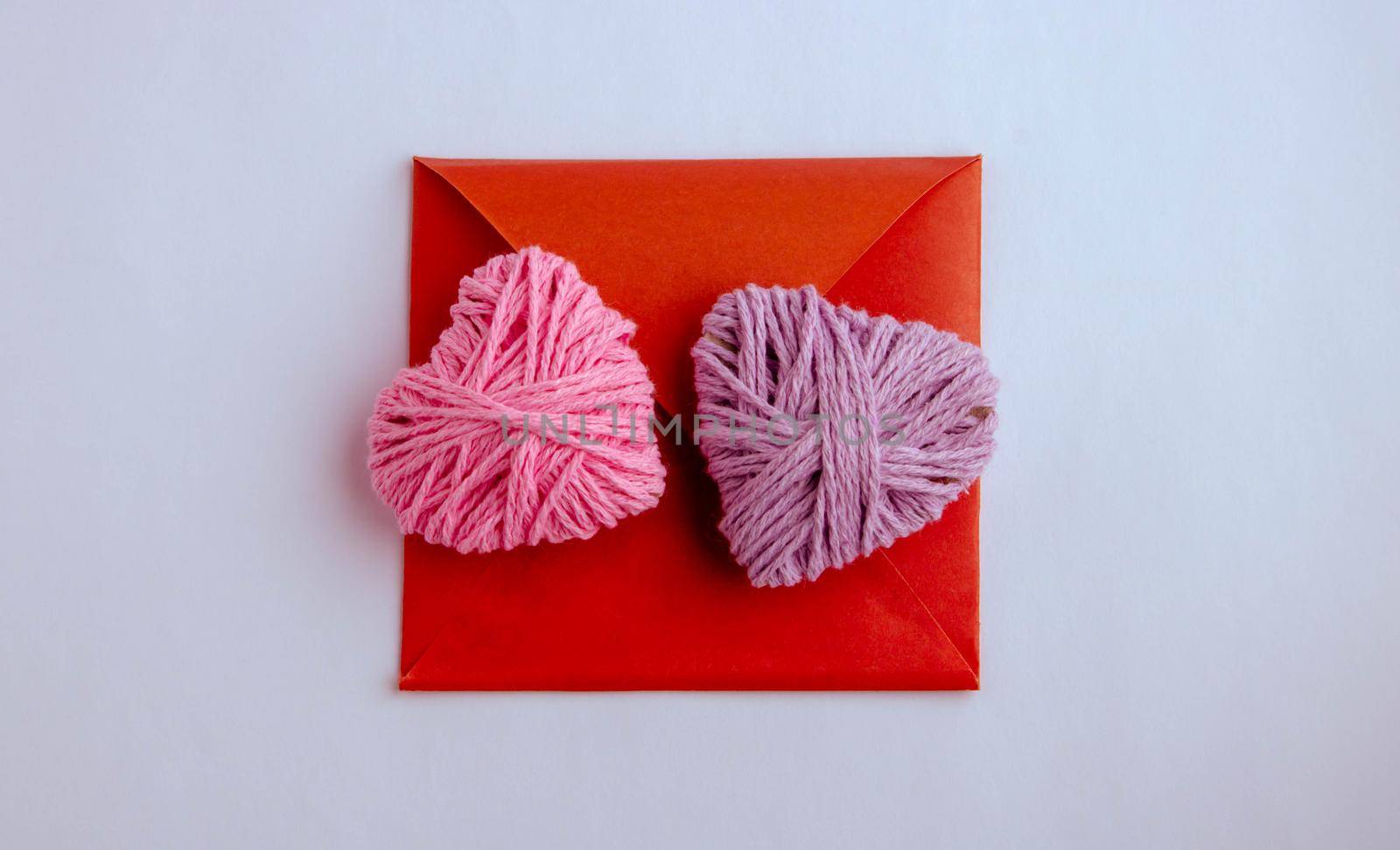 Pink and lilac knitting yarn heart shaped. Valentines day minimal concept. Greeting card with heart on a pink background. Top view. Flat lay. by lapushka62