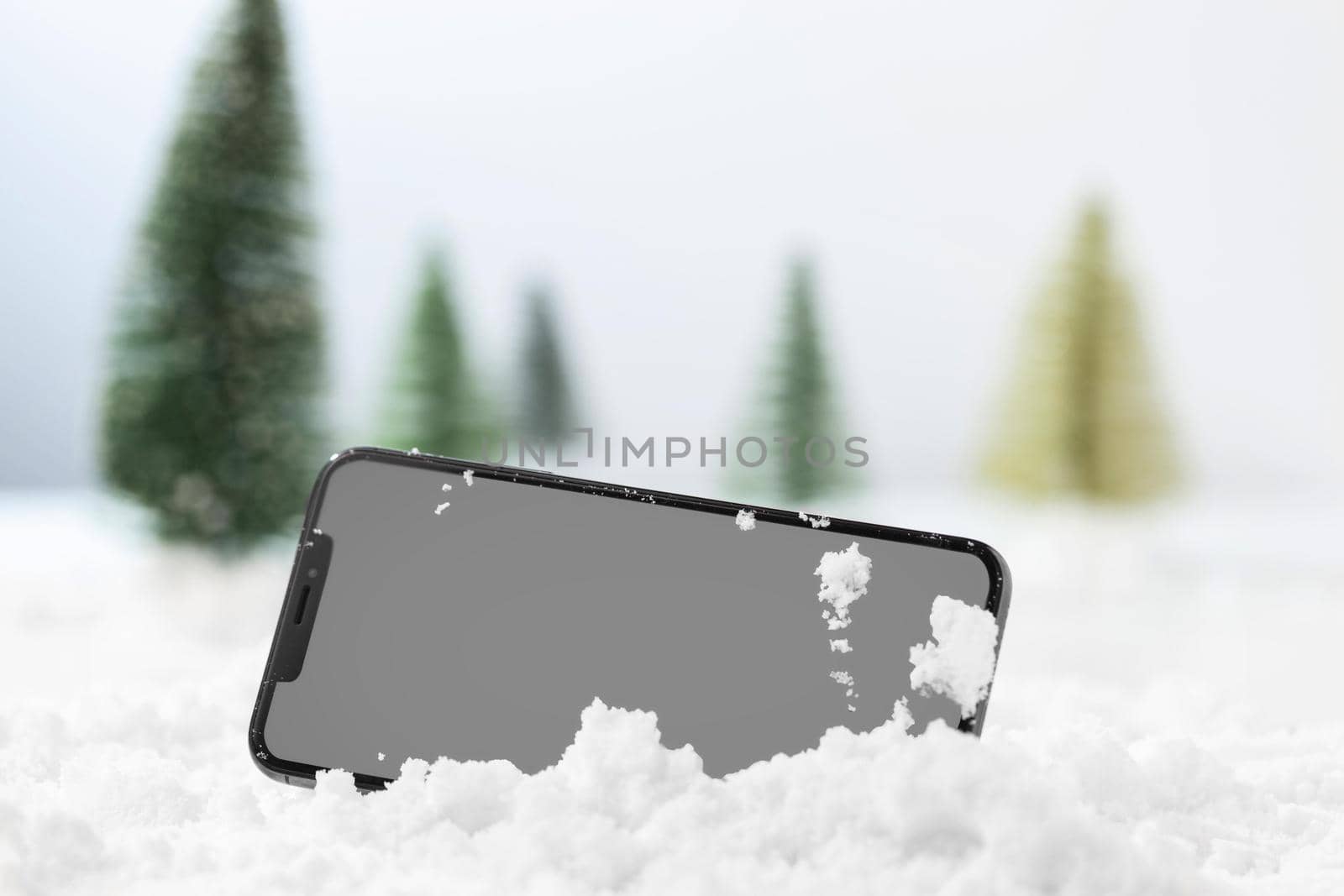 close up view of smartphone in snow