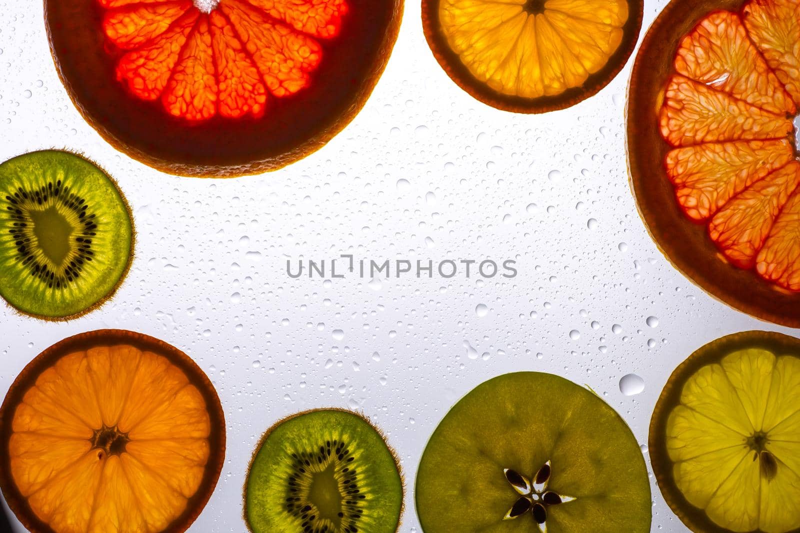 orange grapefruit and kiwi slices on white background