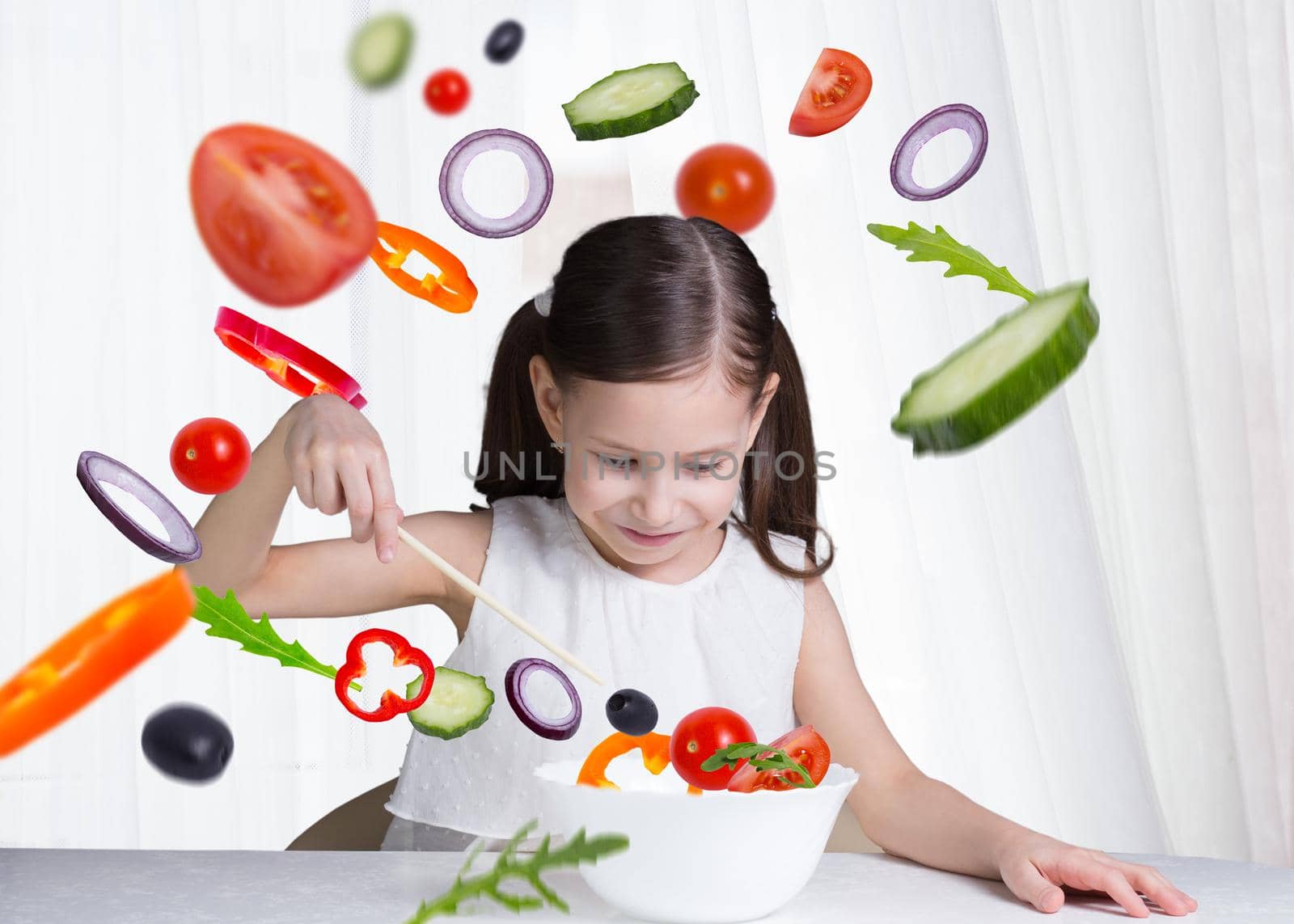 a young beautiful girl eat flying salad