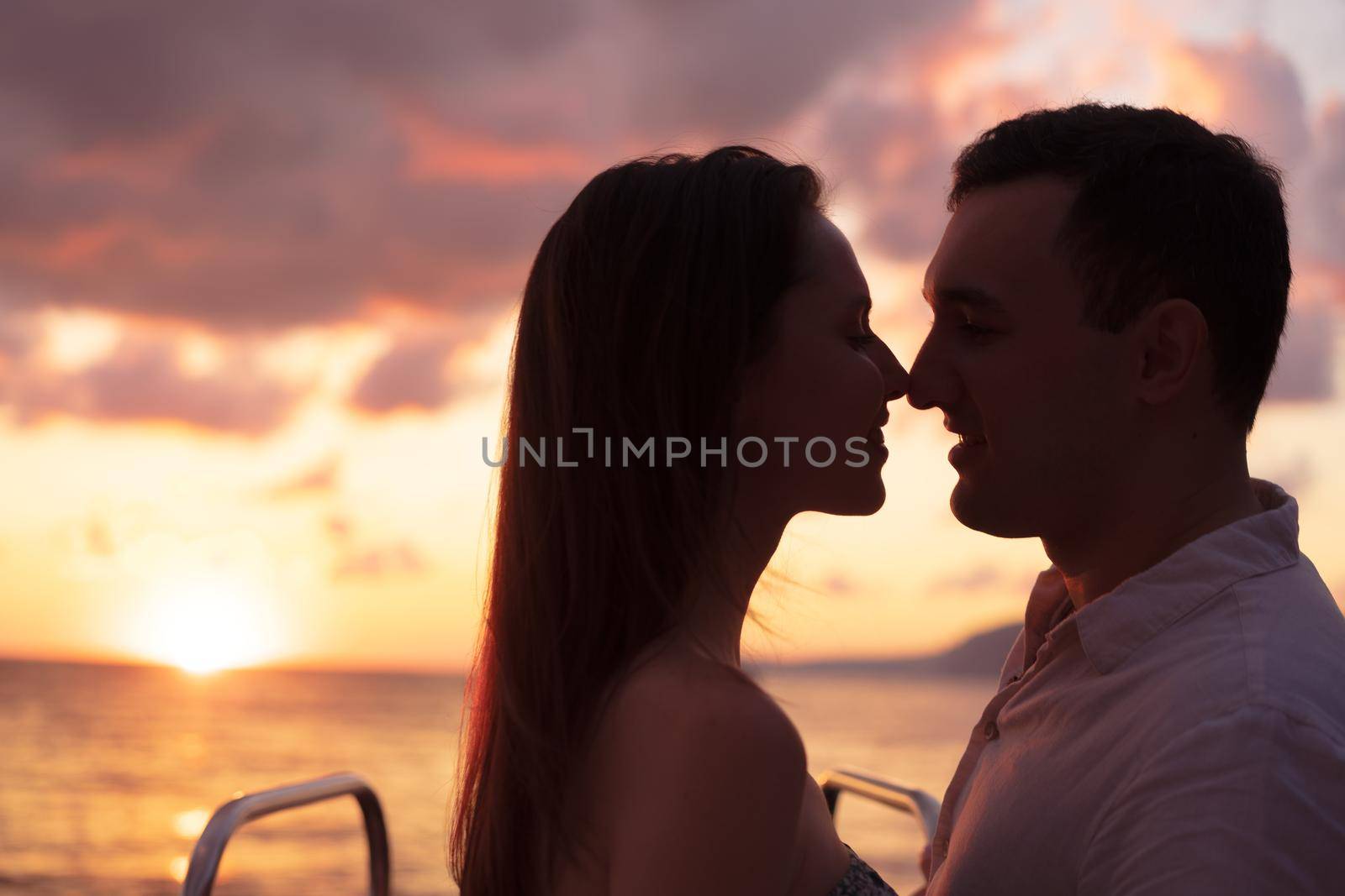 Romantic sensual young couple in love at the sunset by Fabrikasimf