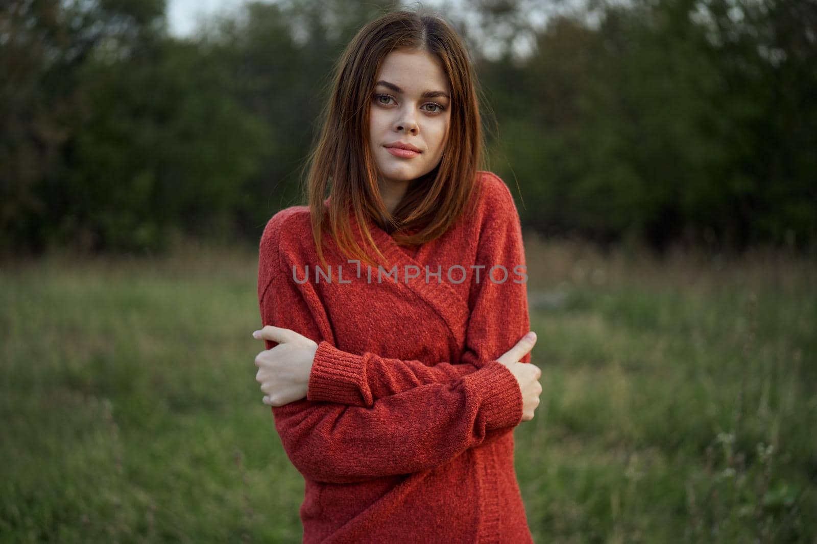 woman in a red sweater outdoors in the field nature rest by Vichizh