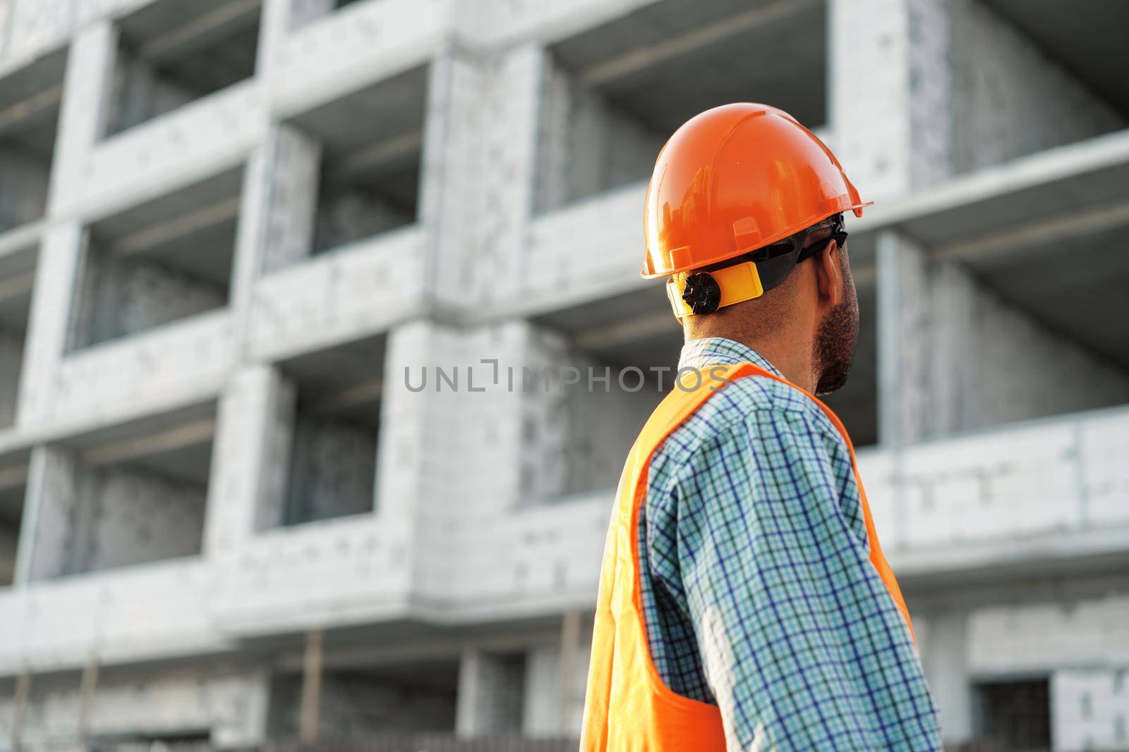 Close up photo of unrecognizable man foreman in workwear on construction site