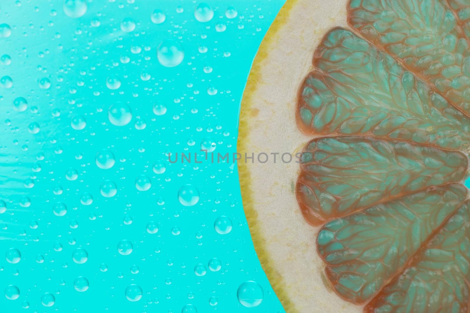 grapefruit slice on green background