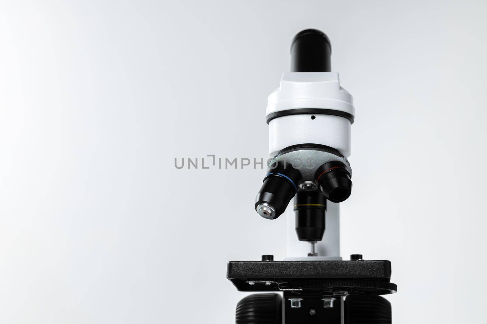 Mo0dern white laboratory microscope on white background, close up