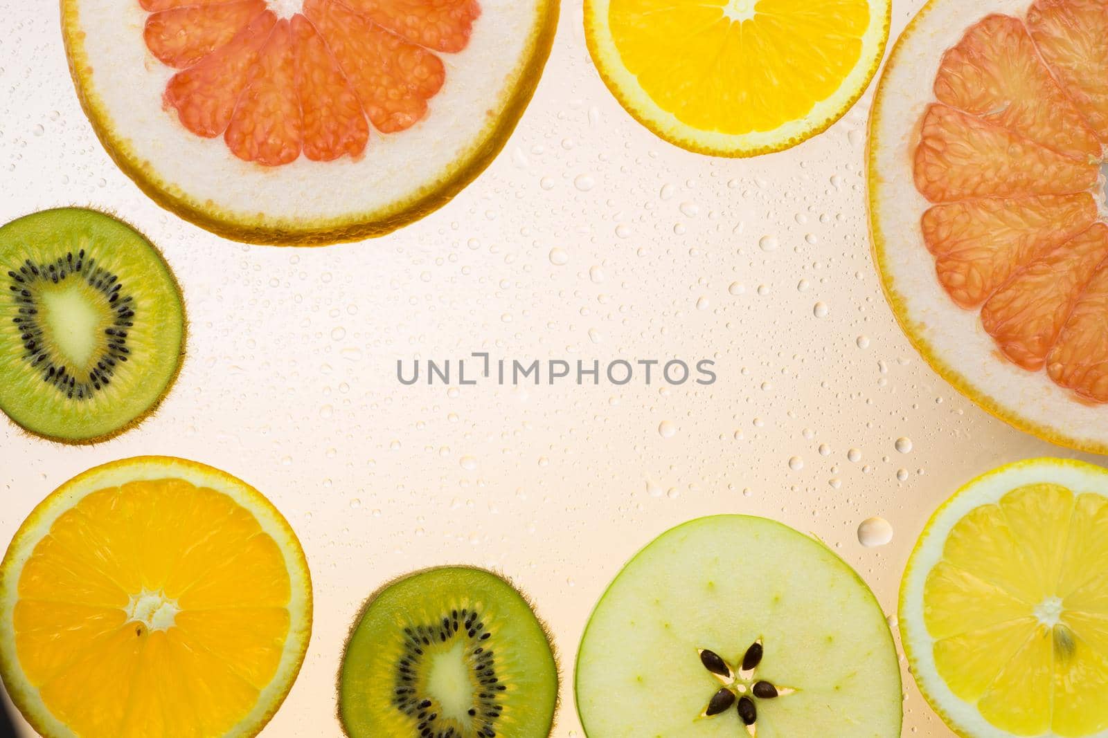 orange grapefruit and kiwi slices on white background