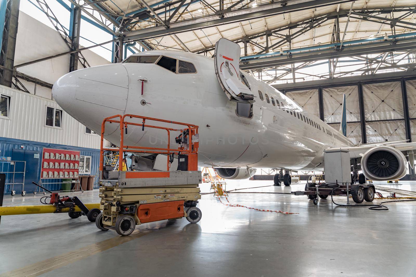Passenger aircraft on maintenance of engine and fuselage repair in hangar by Yaroslav_astakhov