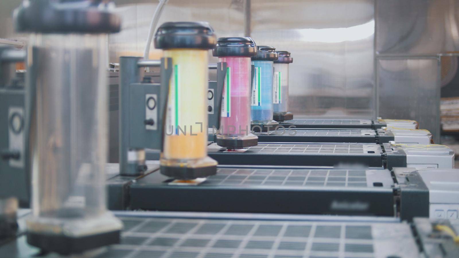 Containers with paints for printing press in the typography, close up