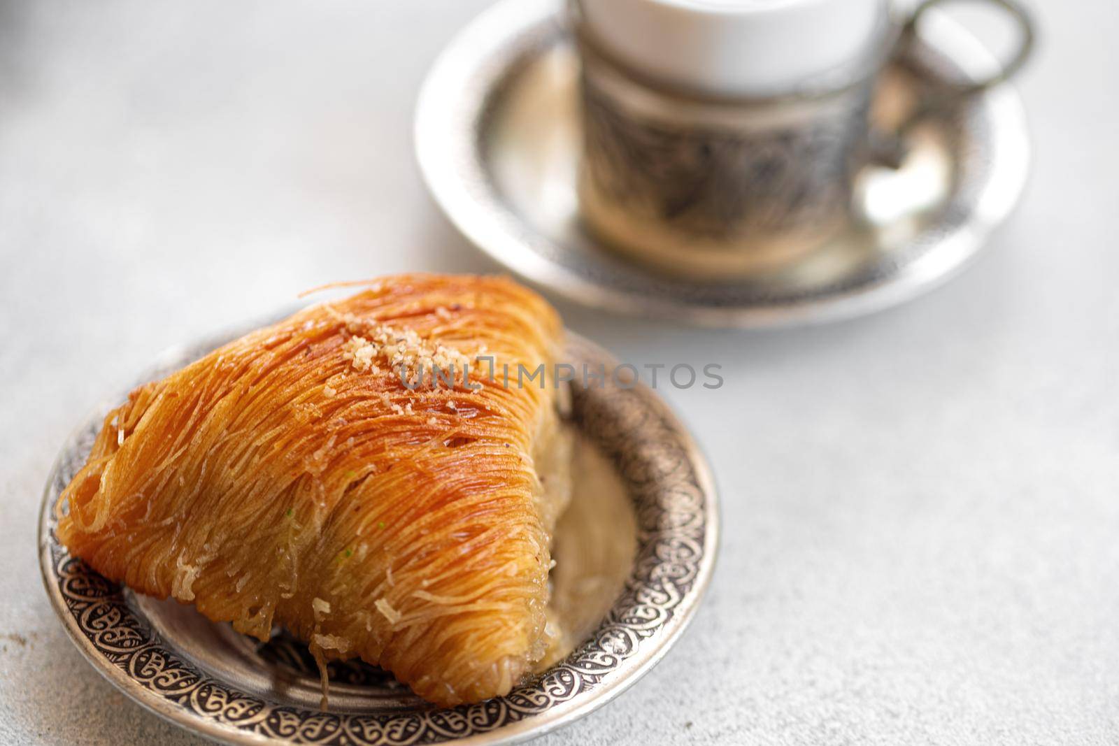 Small cup of Turkish coffee and Turkish baklava on table