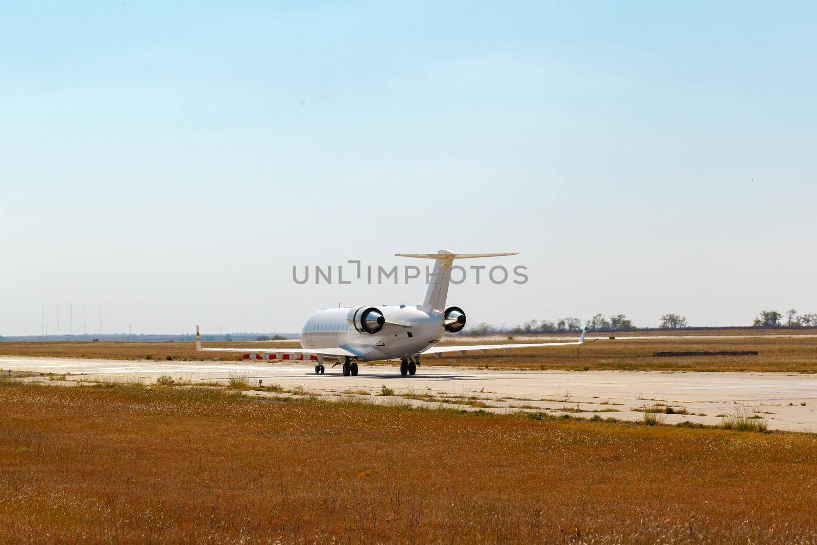 Passenger plane taking off from runway at airport on sunny day photo