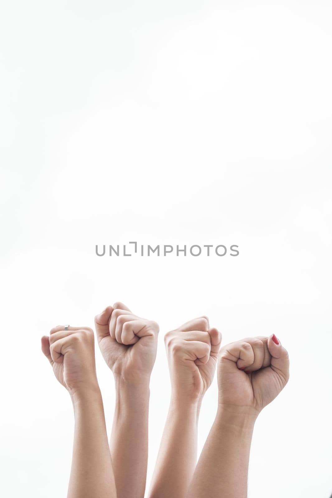 close up women holding fists up gathering