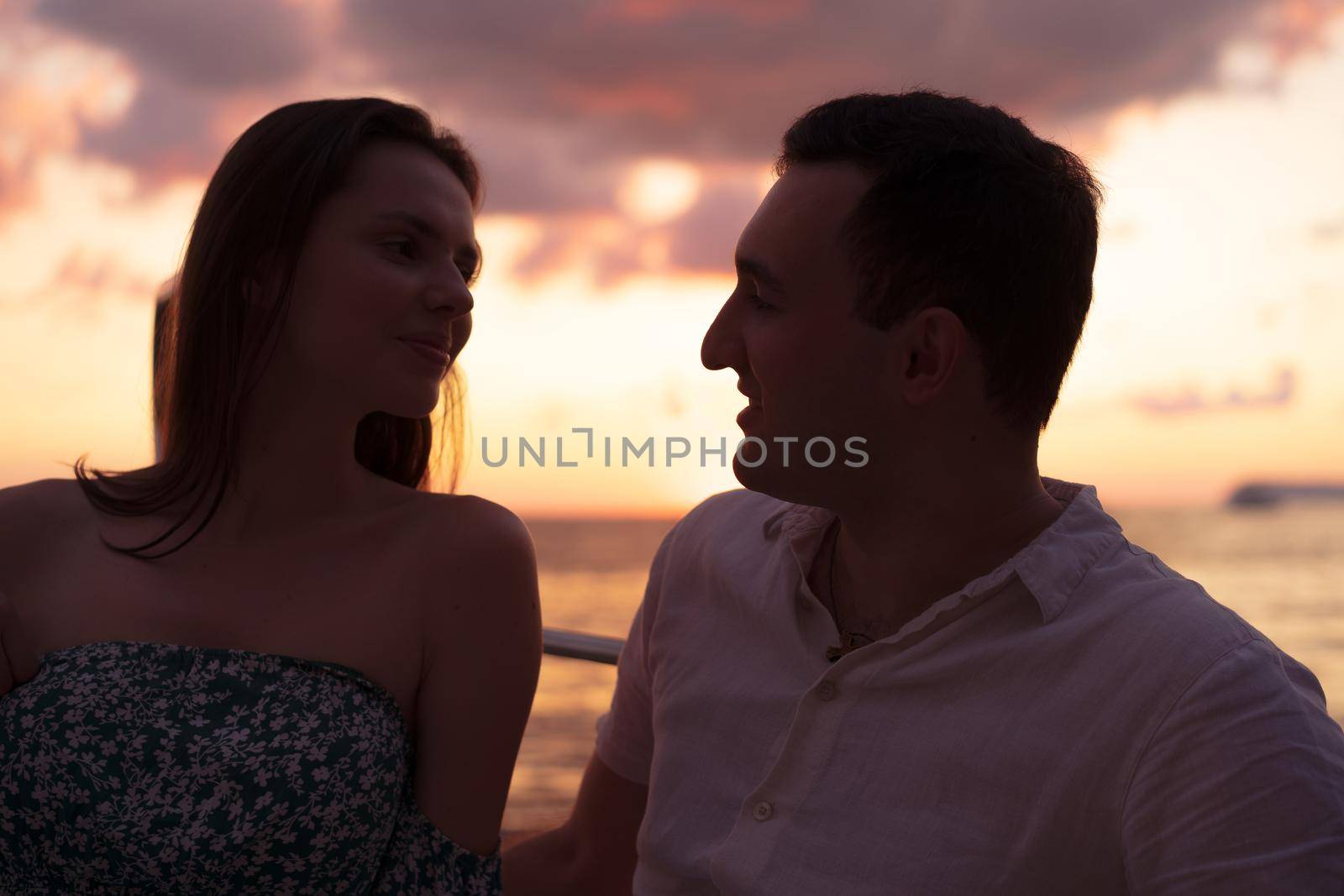 Romantic sensual young couple in love at the sunset, close up