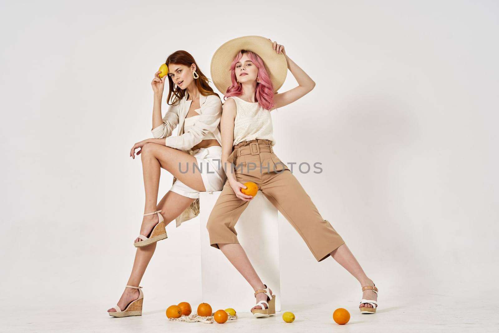 two women fashionable clothes posing accessories summer style by Vichizh