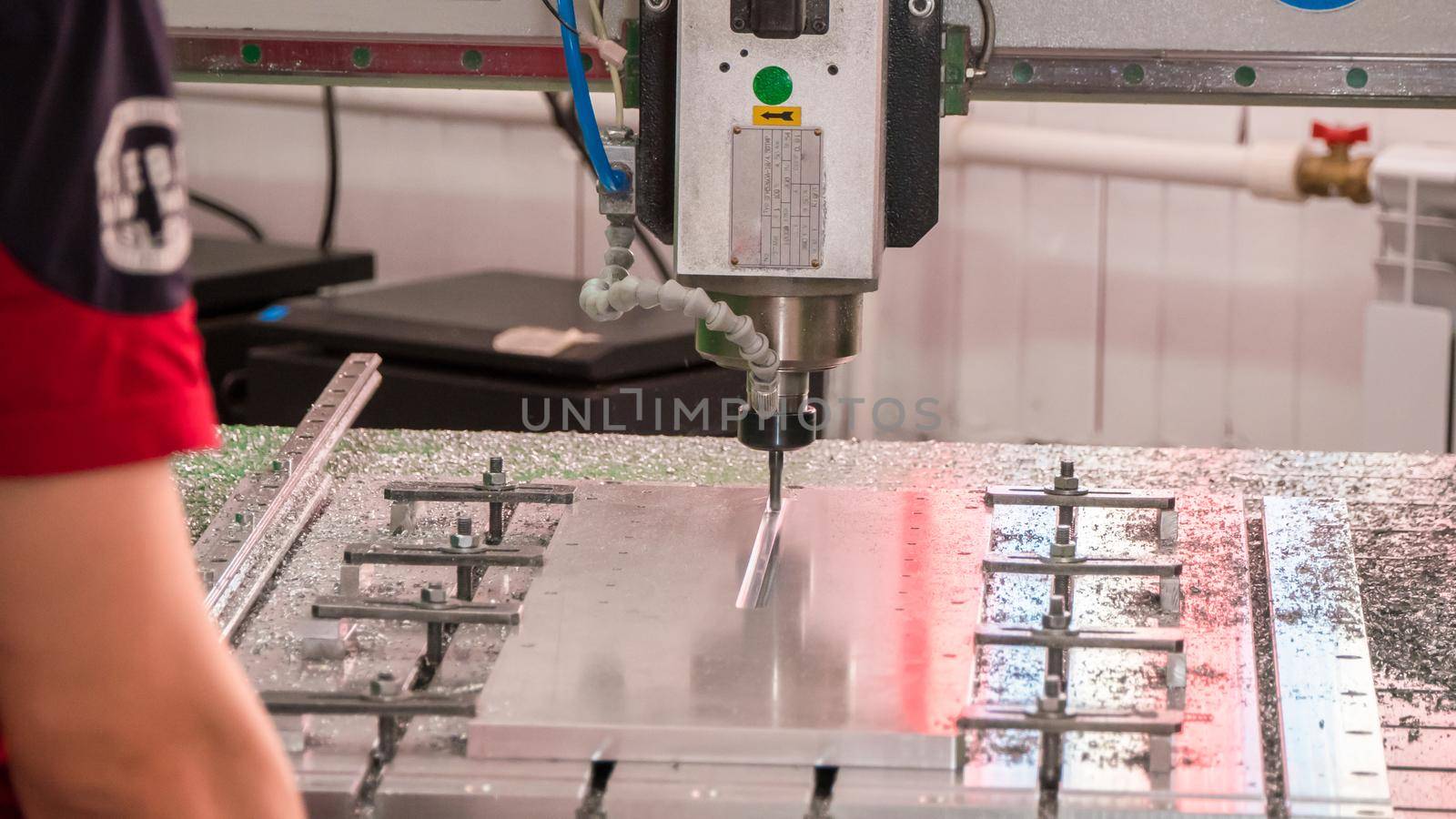Automated CNC equipment for working with metal in action. The programmed robot head. Telephoto shot