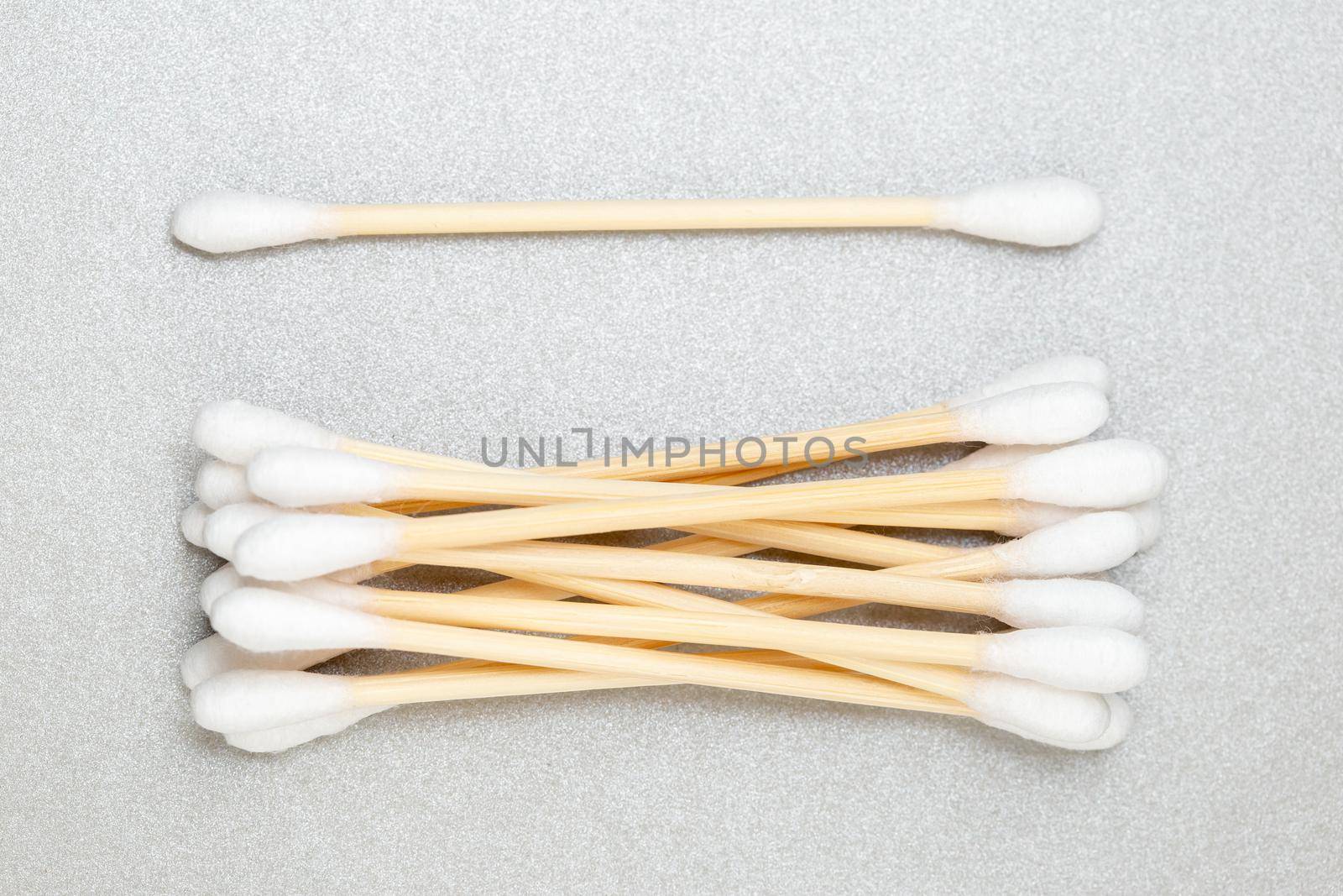 Zero waste bamboo cotton swabs on grey background by Syvanych