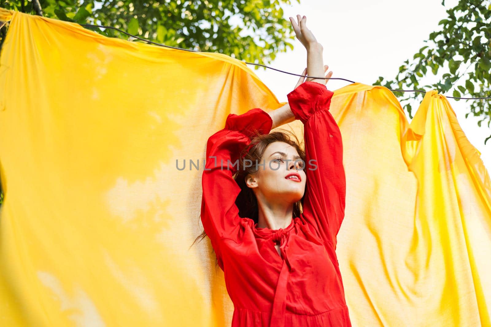 woman in red dress outdoors yellow bedspread by Vichizh