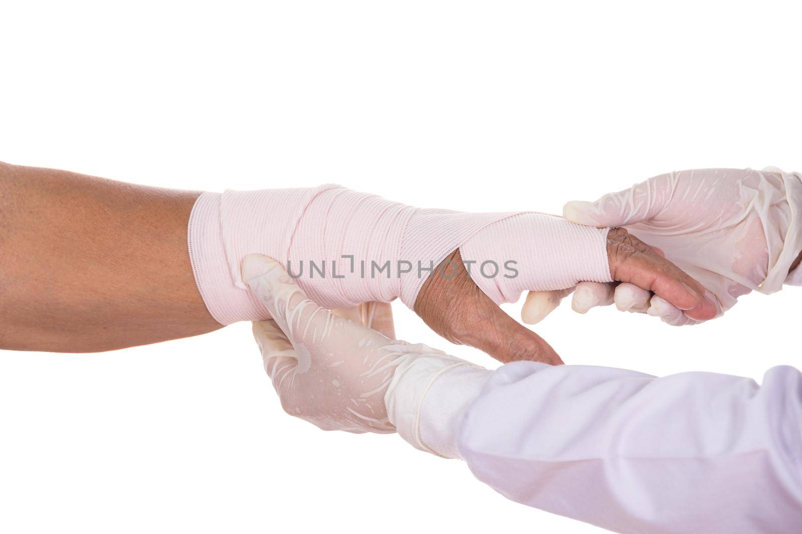 Close-up female doctor is bandaging hand of patient on white background