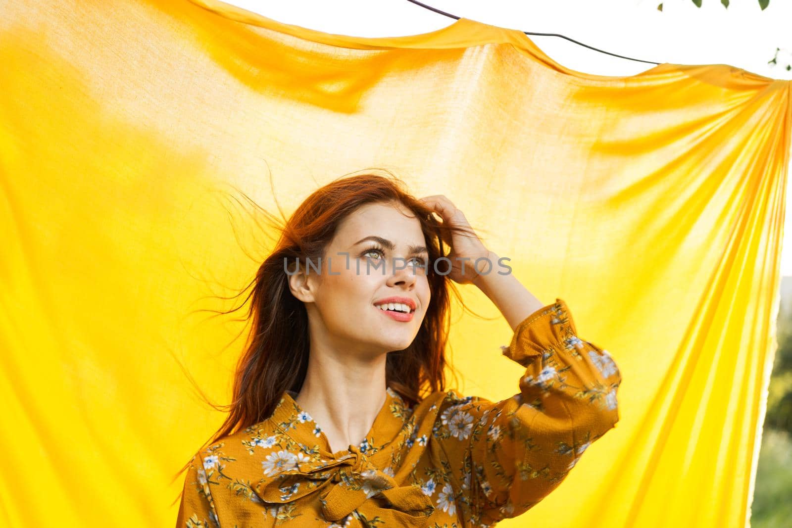 cheerful woman gesturing with her hands yellow background. High quality photo