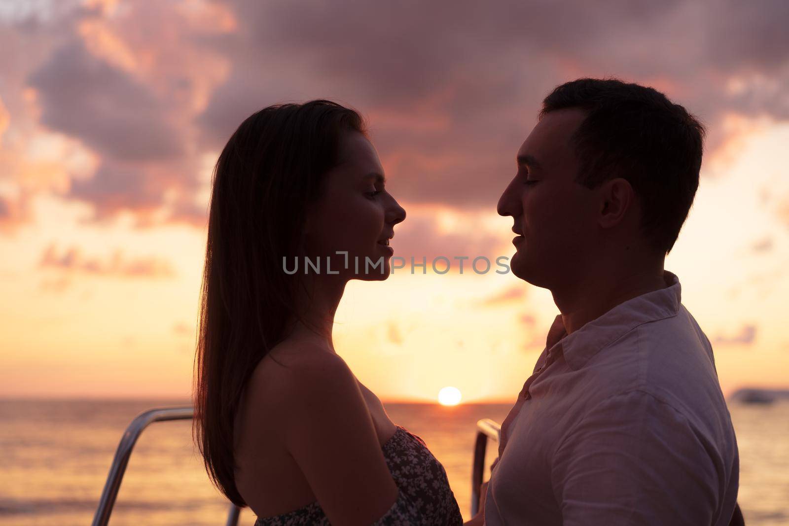 Romantic sensual young couple in love at the sunset, close up