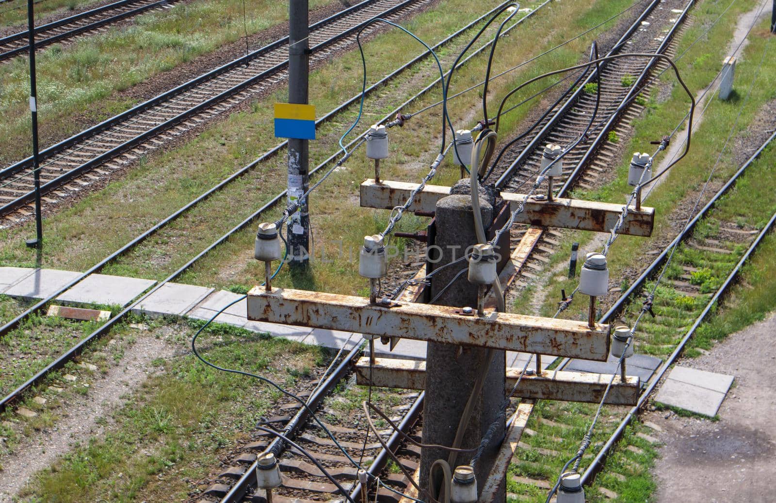 Wooden electric pole with high voltage wires close-up. Old decrepit wooden post at the railway station