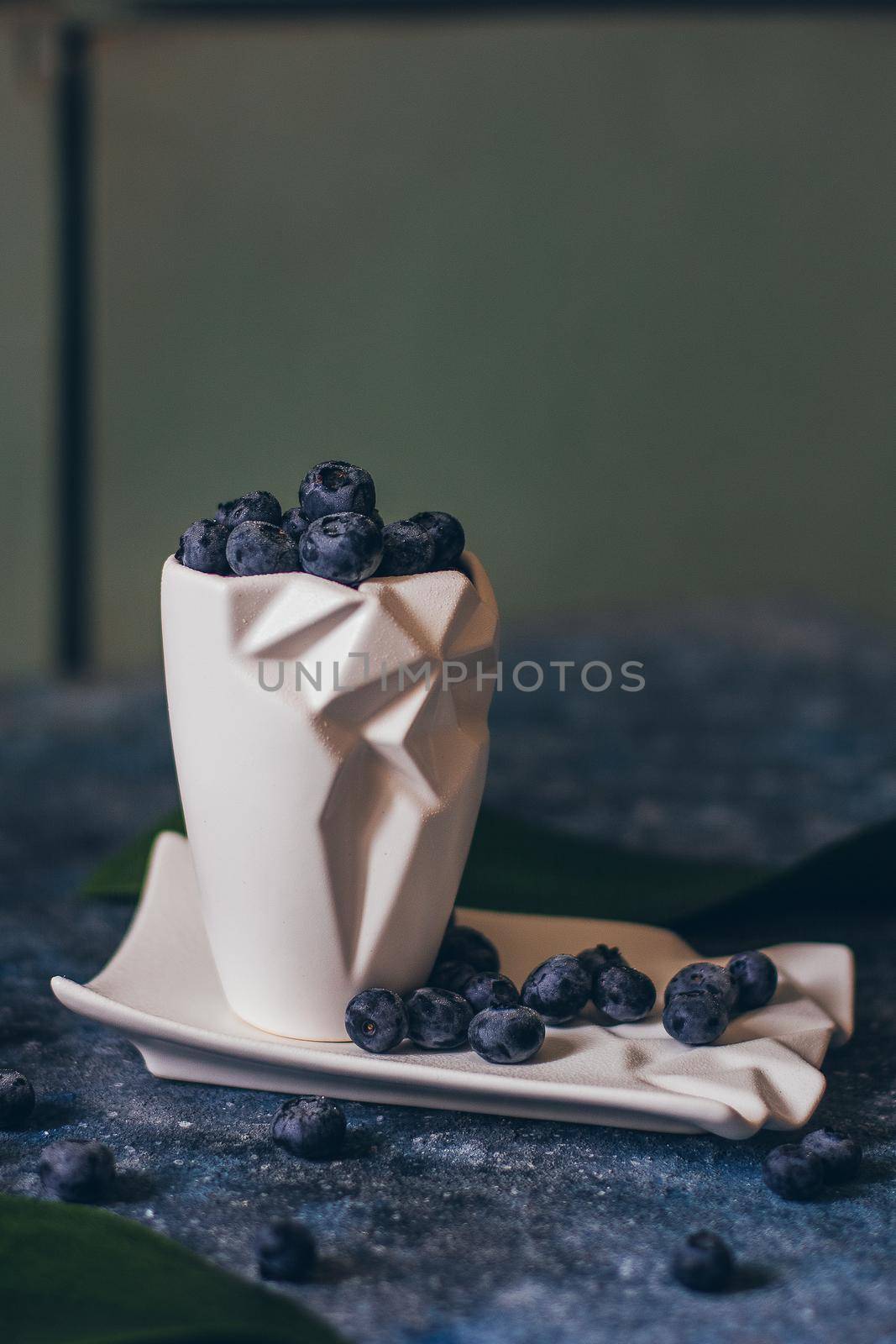 Fresh Blueberries in a bowl on dark background, top view. Juicy wild forest berries, bilberries. Healthy eating or nutrition.