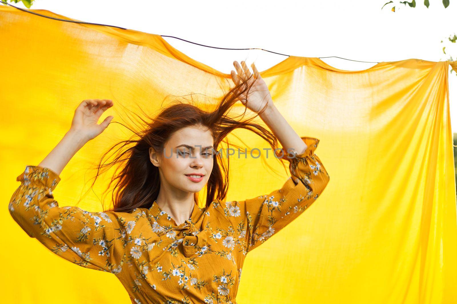 woman in dress posing nature yellow cloth fresh air. High quality photo