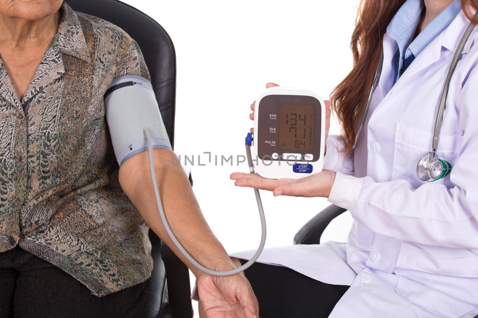 Female doctor measuring blood pressure of senior woman by geargodz
