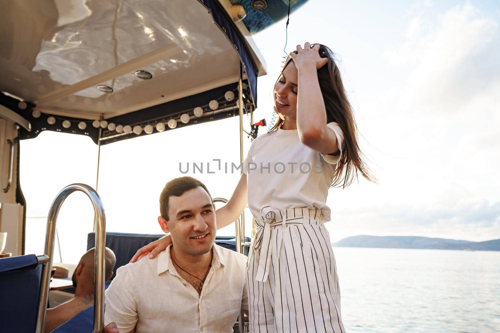 Loving couple spending time on a yacht at the open sea