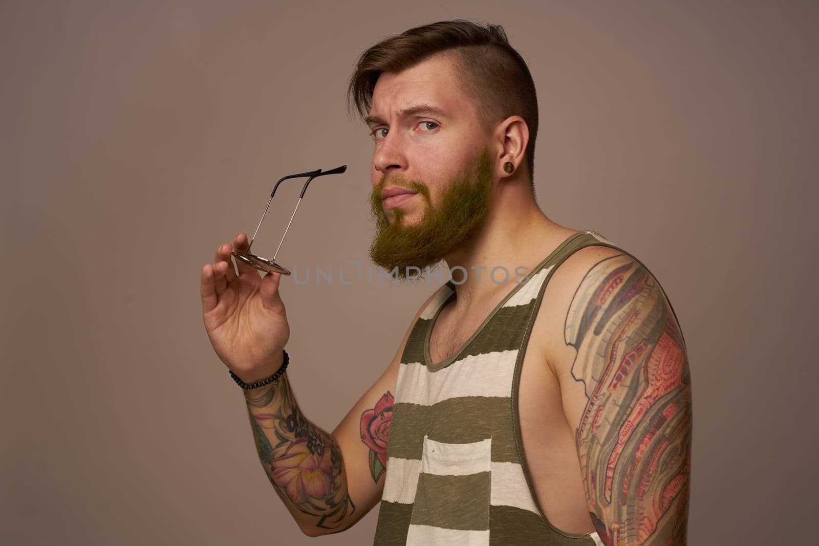 brutal man tattoos on his arms posing lifestyle form cropped view. High quality photo