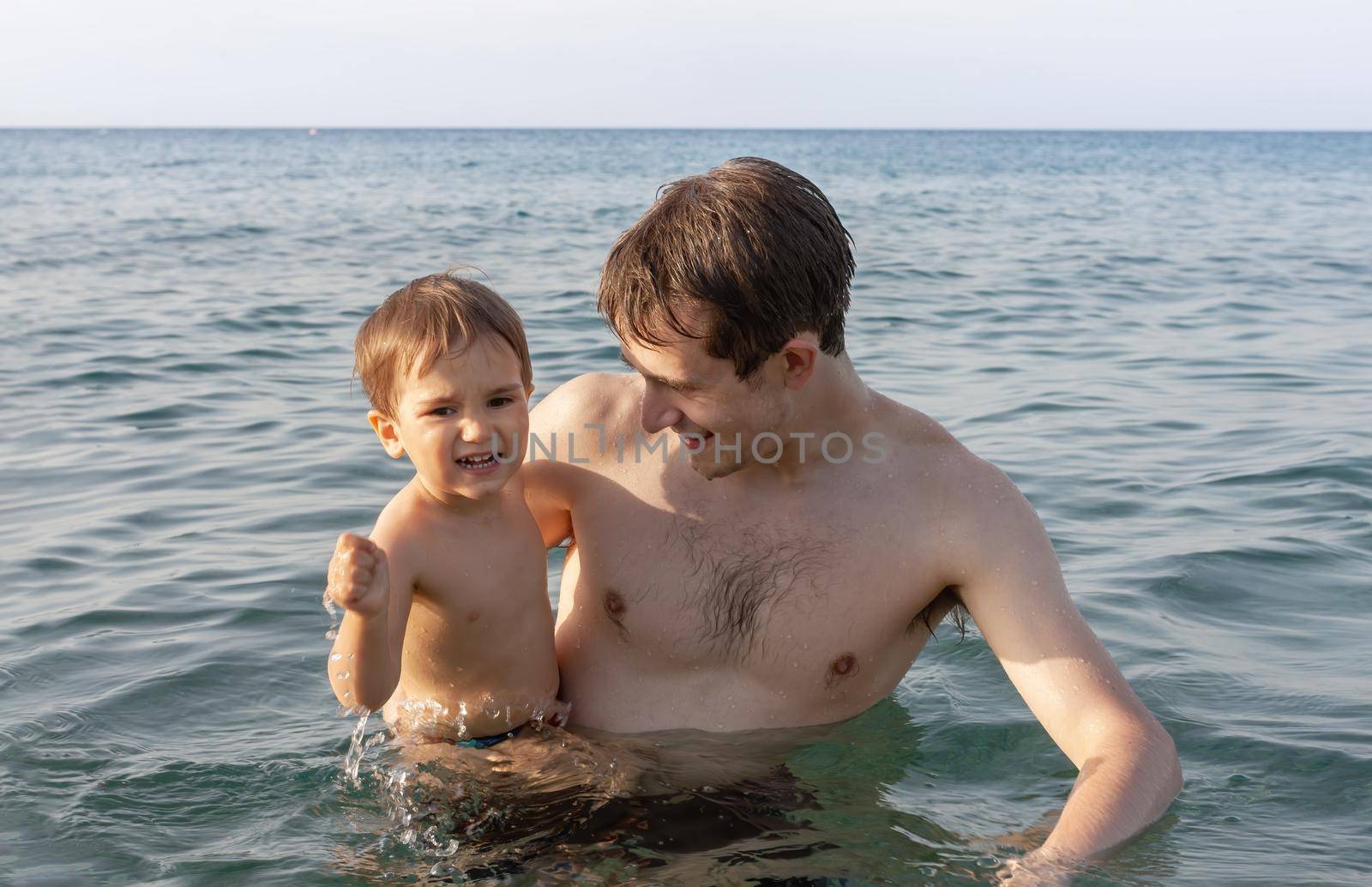 father and child in the sea by palinchak