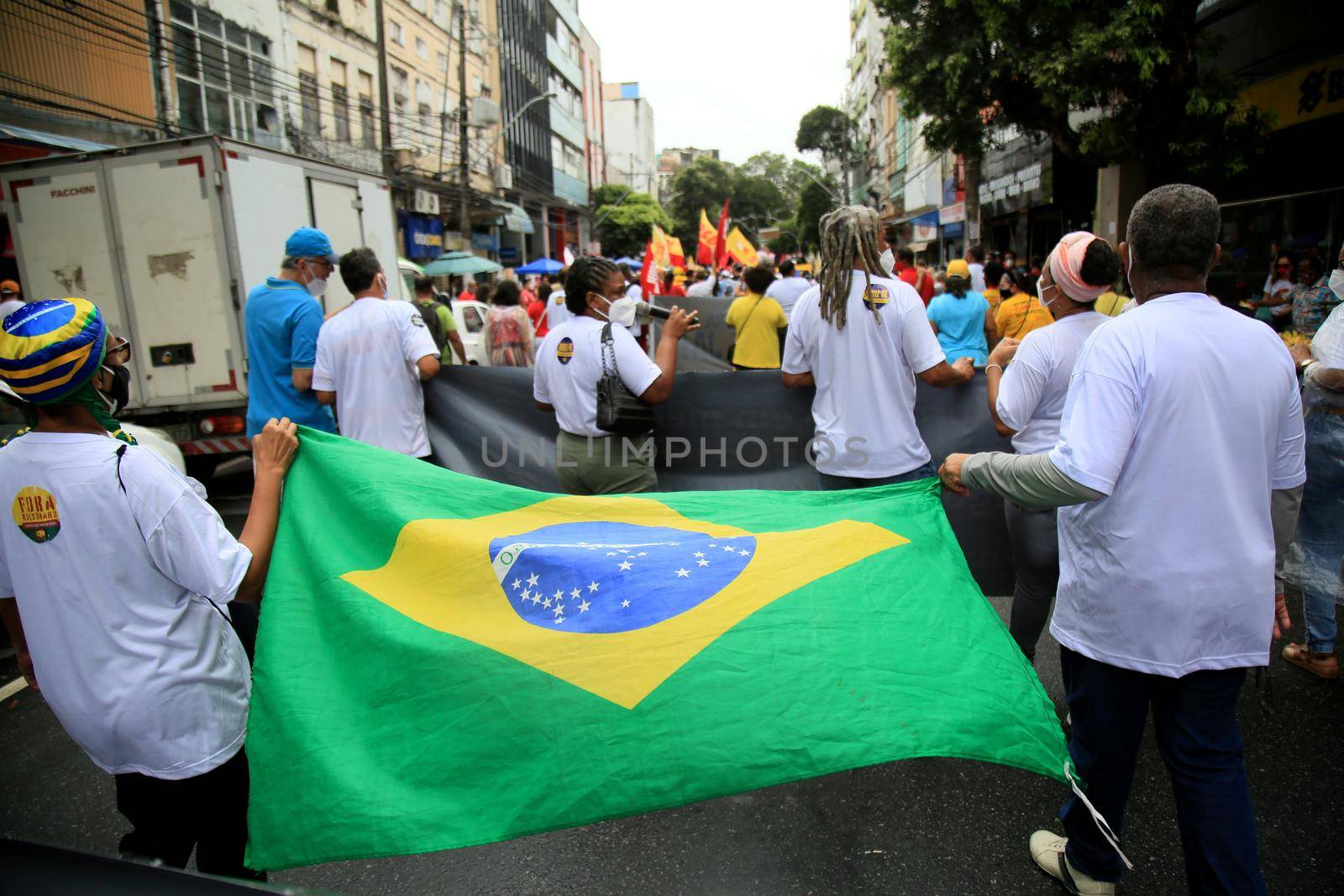 salvador, bahia, brazil - july 24, 2018: protester carries the Brazilian flag during protest against the government of President Jair Bolsonaro in the city of Salvador.
