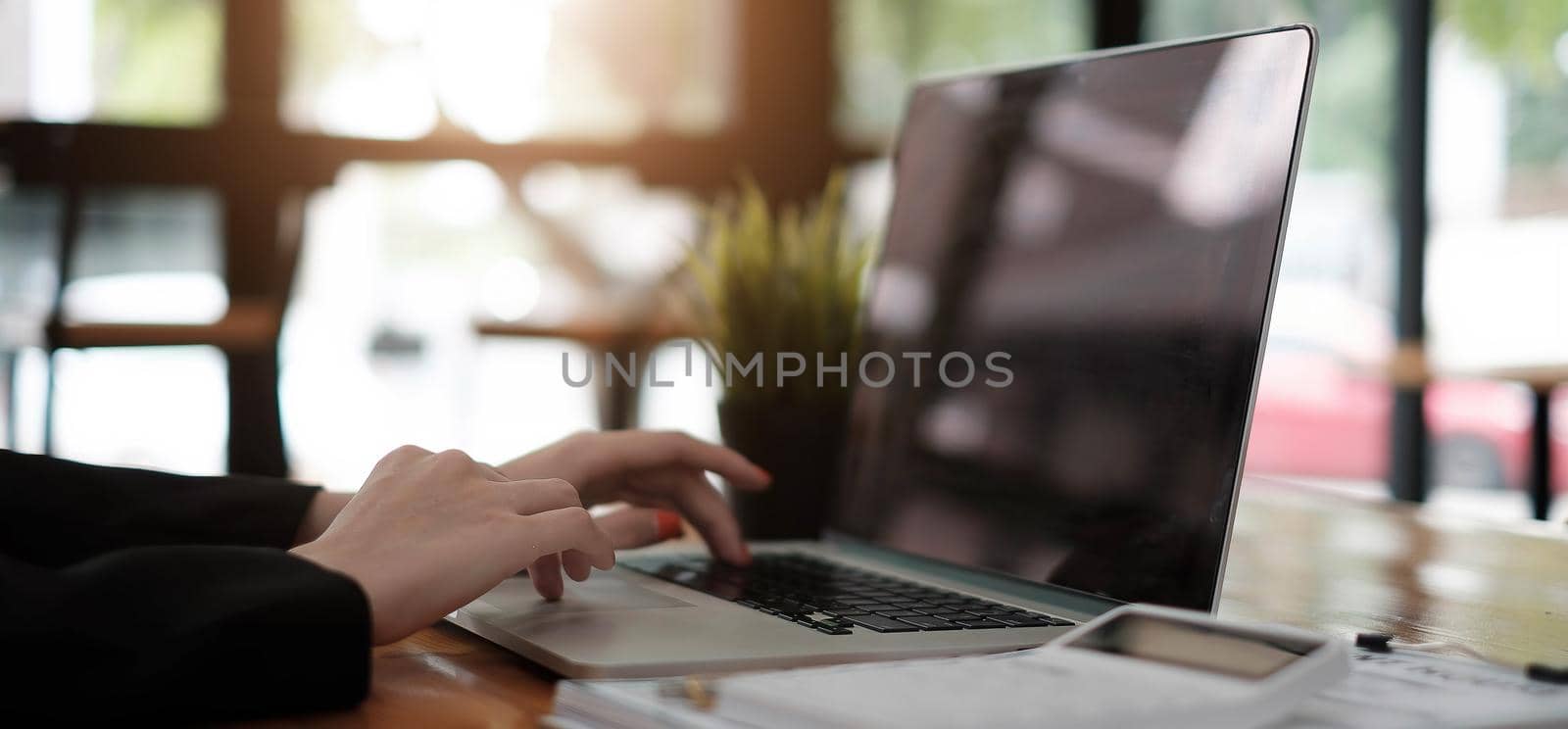 Asian girl working at a office during using laptop computer for financial analysis, tax, cost - Business Financial Concept by wichayada