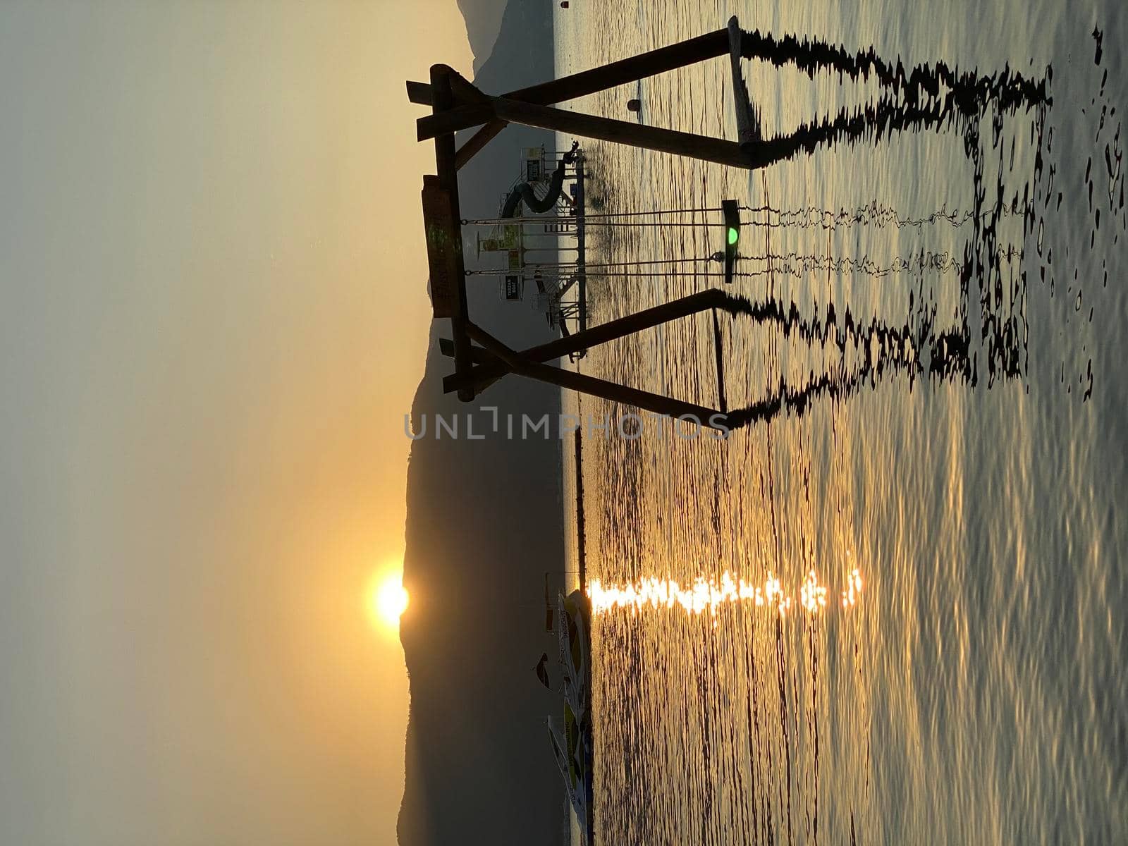 Tourist admiring the sunrise on tropical island - stock photo. High quality photo